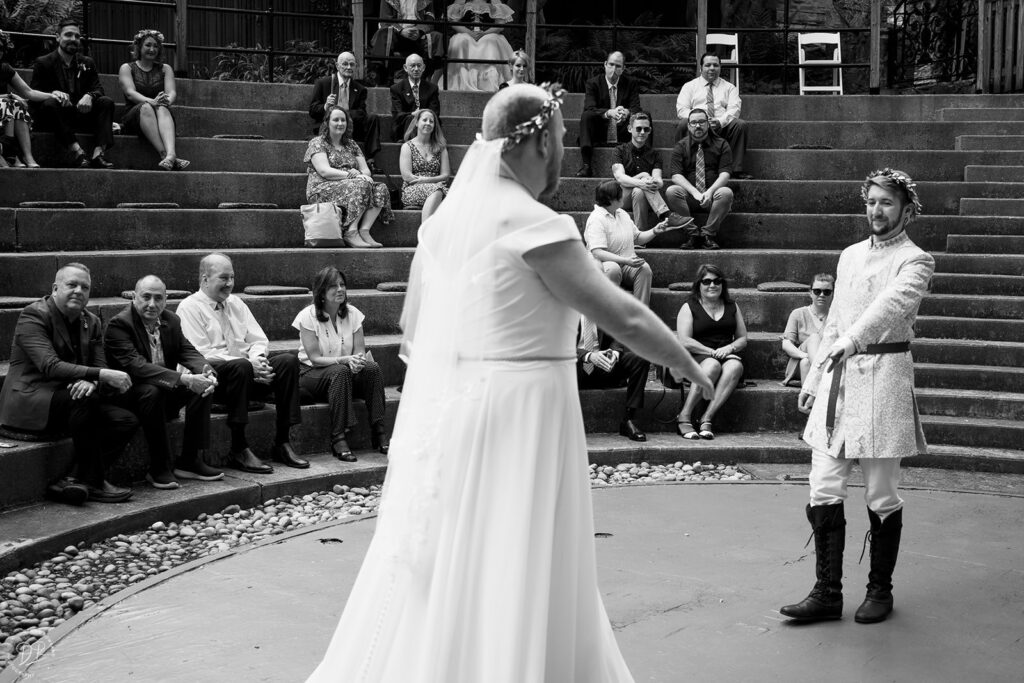 A person reaching out and walking toward their partner during their wedding ceremony 
