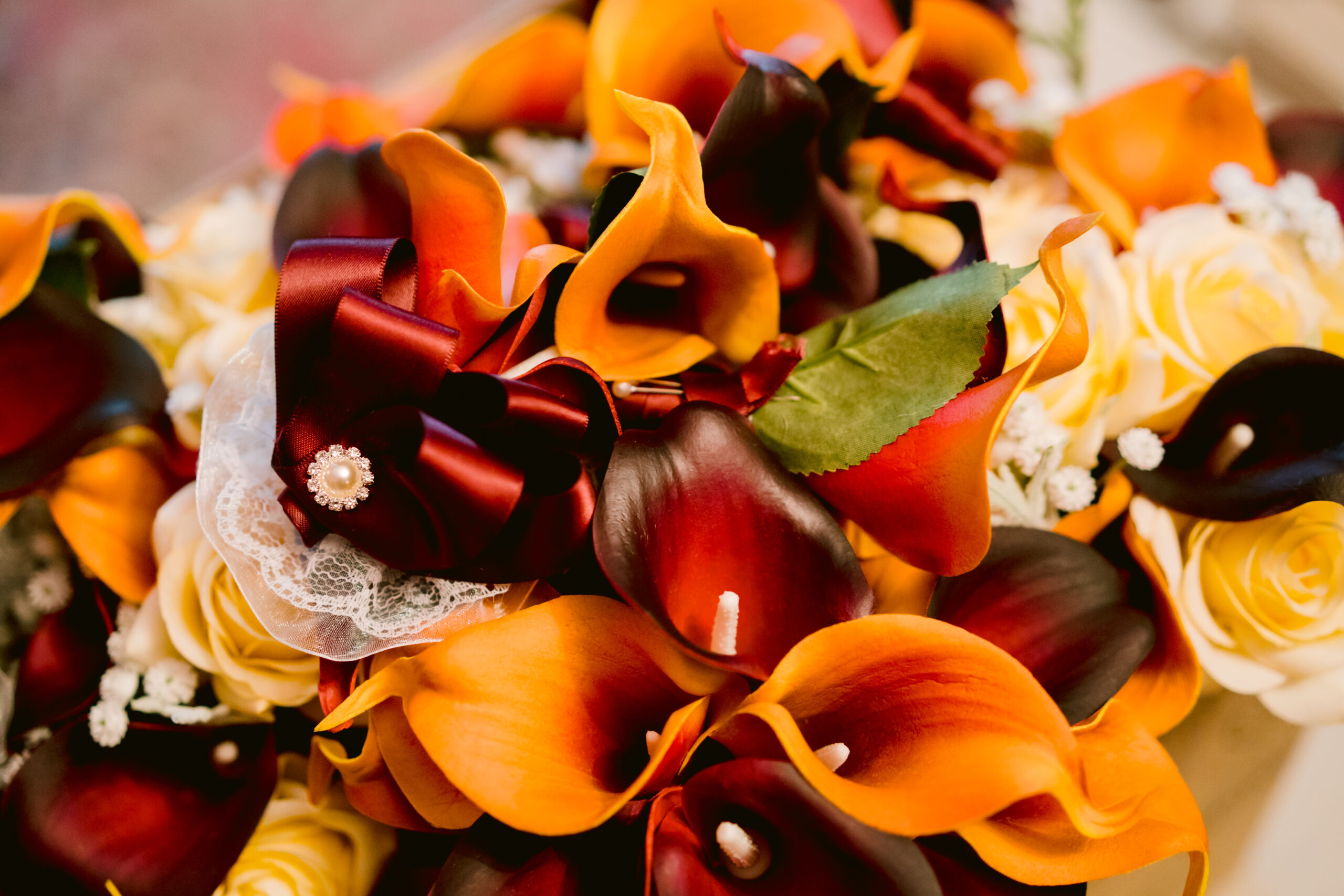 orange, maroon, and white floral boquet 