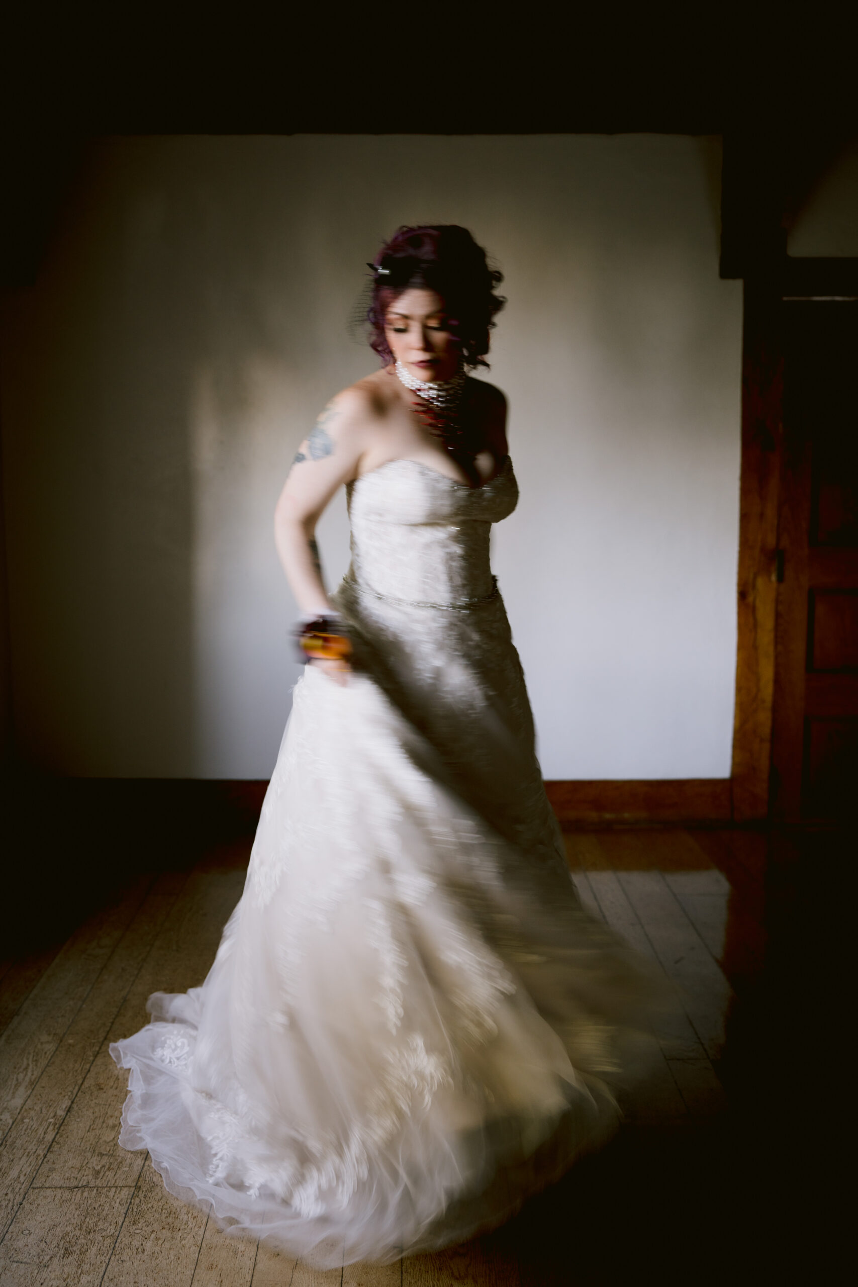 woman in a wedding dress in a room spinning in her wedding dress