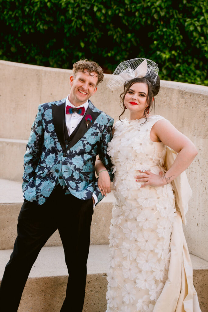 A newlywed couple with their arms linked smiling. 