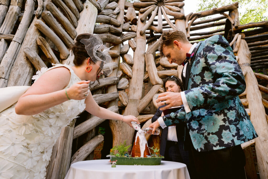 A wedding couple pouring liquid on a volcano at their wedding 