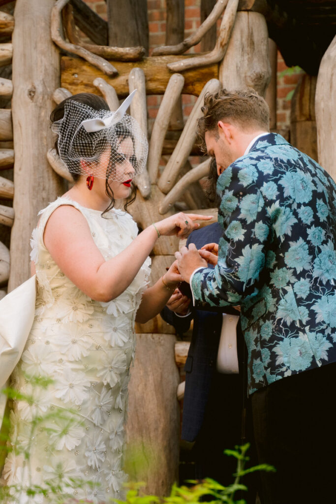 A wedding couple exchanging rings during their ceremony 