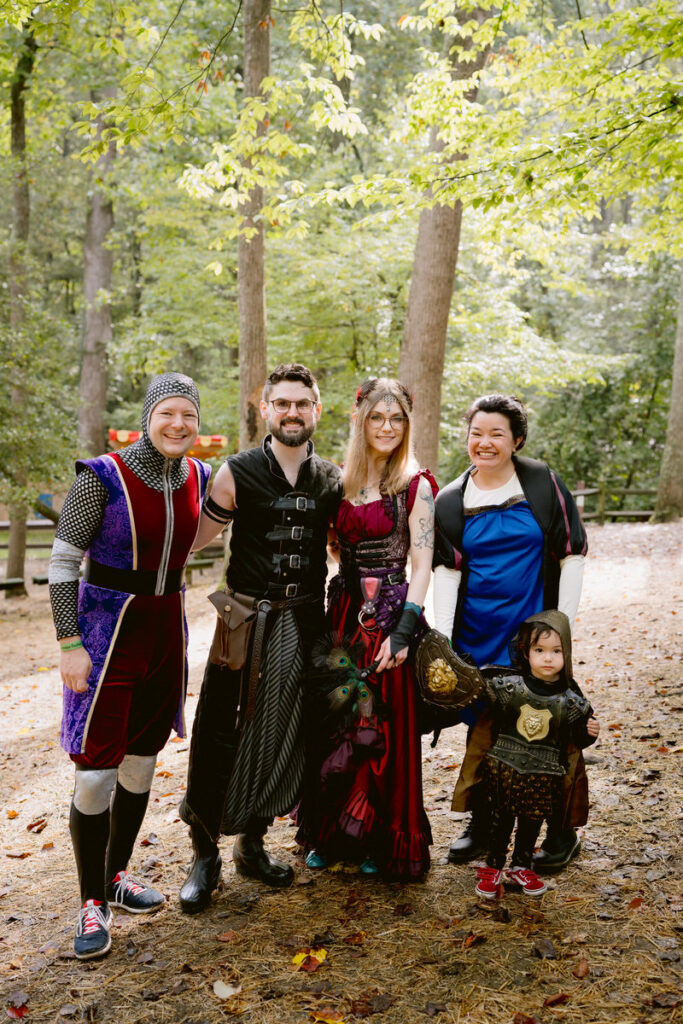 A newlywed couple smiling with wedding dressed who are dressed in Renaissance costumes 
