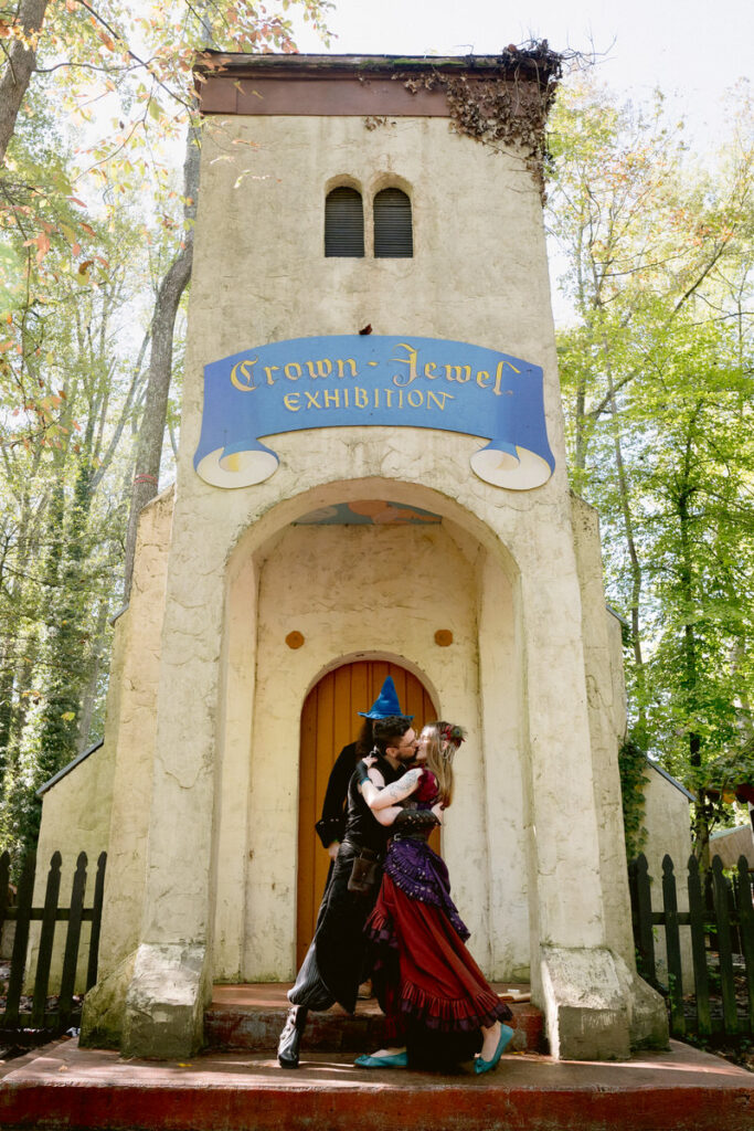 A newlywed couple during their first kiss at their Renaissance Festival wedding 