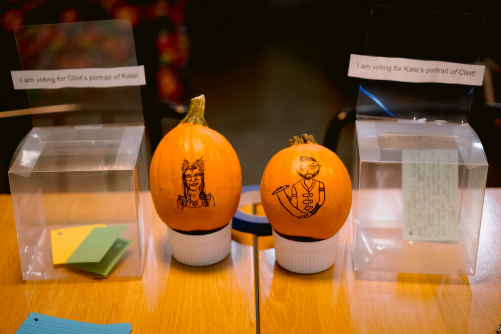 Small pumpkins with hand-drawn portraits on them 